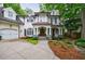 Elegant white brick home featuring a columned front porch and a neatly landscaped yard at 1412 Lanier Ne Mnr, Atlanta, GA 30319