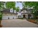 A stately white brick residence featuring a three-car garage, well-manicured landscaping, and a covered front porch at 1412 Lanier Ne Mnr, Atlanta, GA 30319