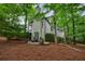 Home's exterior with stone patio featuring seating, nestled amidst trees in a private and serene setting at 1412 Lanier Ne Mnr, Atlanta, GA 30319