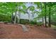 Back exterior with a manicured hillside, stone steps, and a charming patio to enjoy outdoors at 1412 Lanier Ne Mnr, Atlanta, GA 30319