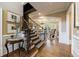 Bright foyer features hardwood floors, staircase, and views into the living room with coffered ceilings at 1412 Lanier Ne Mnr, Atlanta, GA 30319