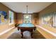 Recreation room features a billiard table, art, and access to a serene outdoor space through French doors at 1412 Lanier Ne Mnr, Atlanta, GA 30319