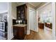 Hallway features a built-in bar area with glass cabinets and access to the kitchen at 1412 Lanier Ne Mnr, Atlanta, GA 30319