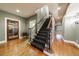 Welcoming hallway with hardwood floors, staircase, and a view of a wine cellar at 1412 Lanier Ne Mnr, Atlanta, GA 30319