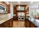 Gourmet kitchen featuring stainless steel appliances, custom cabinets, and a kitchen island with breakfast bar at 1412 Lanier Ne Mnr, Atlanta, GA 30319