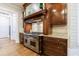 Gourmet kitchen featuring a stainless steel stovetop with custom wood hood and granite countertops at 1412 Lanier Ne Mnr, Atlanta, GA 30319
