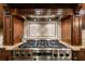 Gourmet kitchen featuring a stainless steel stovetop with custom tile backsplash and granite countertops at 1412 Lanier Ne Mnr, Atlanta, GA 30319