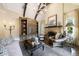 Inviting living room featuring a stone fireplace, exposed beams, and custom built-ins at 1412 Lanier Ne Mnr, Atlanta, GA 30319