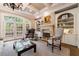 Elegant living room featuring coffered ceilings, fireplace, built-in shelving, and French doors at 1412 Lanier Ne Mnr, Atlanta, GA 30319