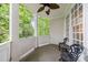 Relaxing screened porch with dark furniture and a ceiling fan overlooking the lush backyard at 1412 Lanier Ne Mnr, Atlanta, GA 30319