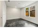 A bright bedroom with smooth concrete floors, a large window with natural light, and modern white walls at 241 Maynard Se Ter # 18, Atlanta, GA 30316