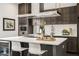 Modern kitchen featuring an island, wine cooler, dark cabinets, stainless steel appliances, and decorative lighting at 241 Maynard Se Ter # 18, Atlanta, GA 30316