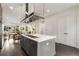 Open concept kitchen with island, stainless steel appliances, and hardwood floors at 241 Maynard Se Ter # 18, Atlanta, GA 30316