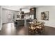Open-concept living space with a modern kitchen, dining area, and dark hardwood flooring throughout at 241 Maynard Se Ter # 18, Atlanta, GA 30316