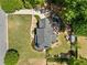 Aerial view of a home with a lush yard, mature trees, a spacious back deck, and convenient shed at 4013 Dover Ave, Alpharetta, GA 30009