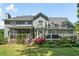 Expansive backyard featuring a deck, screened porch, lush landscaping, and a well-maintained lawn at 4013 Dover Ave, Alpharetta, GA 30009