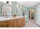 Bright bathroom showcasing a double sink vanity, modern mirrors, and a glass-enclosed shower at 4013 Dover Ave, Alpharetta, GA 30009