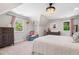 Bright bedroom with a pitched ceiling, chandelier, and comfortable furnishings at 4013 Dover Ave, Alpharetta, GA 30009