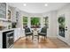 Charming breakfast nook with natural light, features hardwood floors and bar with beverage fridge at 4013 Dover Ave, Alpharetta, GA 30009
