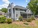 Rear exterior of a gray two-story home with a patio, sunroom, and well-manicured landscaping at 4013 Dover Ave, Alpharetta, GA 30009