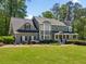 Attractive two-story home with dormers and a turret featuring a well-maintained lawn and landscaping at 4013 Dover Ave, Alpharetta, GA 30009