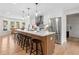 Bright kitchen with stainless steel appliances, white cabinets, quartz countertops, and a large island with stools at 4013 Dover Ave, Alpharetta, GA 30009