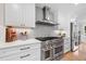 Modern kitchen features stainless steel appliances, white cabinets, and stylish tile backsplash at 4013 Dover Ave, Alpharetta, GA 30009