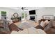 Spacious living room with ceiling fan, brick fireplace, flat screen TV, and a comfortable sectional couch at 4013 Dover Ave, Alpharetta, GA 30009