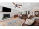 Comfortable living room with a brick fireplace, leather sofa, and large area rug at 4013 Dover Ave, Alpharetta, GA 30009