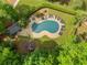 Stunning aerial view of a private backyard pool surrounded by lush landscaping and lounge chairs at 4013 Dover Ave, Alpharetta, GA 30009