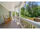 Relaxing covered porch with rocking chairs overlooks the lush, green backyard at 4013 Dover Ave, Alpharetta, GA 30009