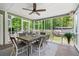 Relaxing screened porch with a dining table, ceiling fan, and serene views of the lush backyard at 4013 Dover Ave, Alpharetta, GA 30009