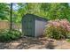 Outdoor storage shed surrounded by mature greenery and foliage on a well maintained lot at 4013 Dover Ave, Alpharetta, GA 30009