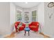 Cozy nook with two red chairs, a blue stool, and natural light streaming through the bay window at 4013 Dover Ave, Alpharetta, GA 30009