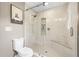 Modern bathroom with walk-in shower, decorative tile, and built-in shelves, complemented by a plush white toilet at 4013 Dover Ave, Alpharetta, GA 30009