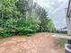 Expansive backyard bordered by mature trees and a privacy fence at 5584 Dendy Trce, Fairburn, GA 30213