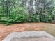 Spacious backyard with lush green trees providing privacy and shade at 5584 Dendy Trce, Fairburn, GA 30213