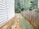 Side view of a home with a wooden fence in the backyard that is mostly dirt at 5584 Dendy Trce, Fairburn, GA 30213