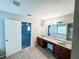 Bright bathroom featuring double vanities, granite counters, tile flooring, and separate tub at 5584 Dendy Trce, Fairburn, GA 30213