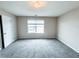Bedroom with neutral walls, carpet, and a window at 5584 Dendy Trce, Fairburn, GA 30213