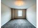 This bedroom features a window and carpet flooring, offering a cozy space for relaxation at 5584 Dendy Trce, Fairburn, GA 30213