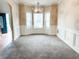 Formal dining room with elegant lighting and wainscoting, perfect for entertaining guests at 5584 Dendy Trce, Fairburn, GA 30213