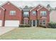 Two-story brick home with a well-kept lawn, showcasing traditional architecture and curb appeal at 5584 Dendy Trce, Fairburn, GA 30213