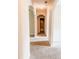 Hallway featuring carpet, archways, and access to multiple rooms at 5584 Dendy Trce, Fairburn, GA 30213