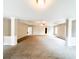 Large, carpeted living room with white trim, natural lighting, and ceiling fan at 5584 Dendy Trce, Fairburn, GA 30213