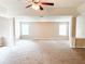 Bright, spacious living room featuring neutral walls, columns, and ample natural light at 5584 Dendy Trce, Fairburn, GA 30213