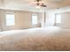 Spacious carpeted living room with large windows and tray ceiling at 5584 Dendy Trce, Fairburn, GA 30213