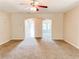 Open-concept living room with arched doorways, creating a seamless flow to the dining area at 5584 Dendy Trce, Fairburn, GA 30213