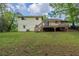 Two-story home with walkout to backyard, deck, and lush green lawn at 8431 Magnolia Dr, Jonesboro, GA 30238