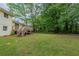 Spacious backyard, two-story home with wooden deck, and lush green lawn at 8431 Magnolia Dr, Jonesboro, GA 30238